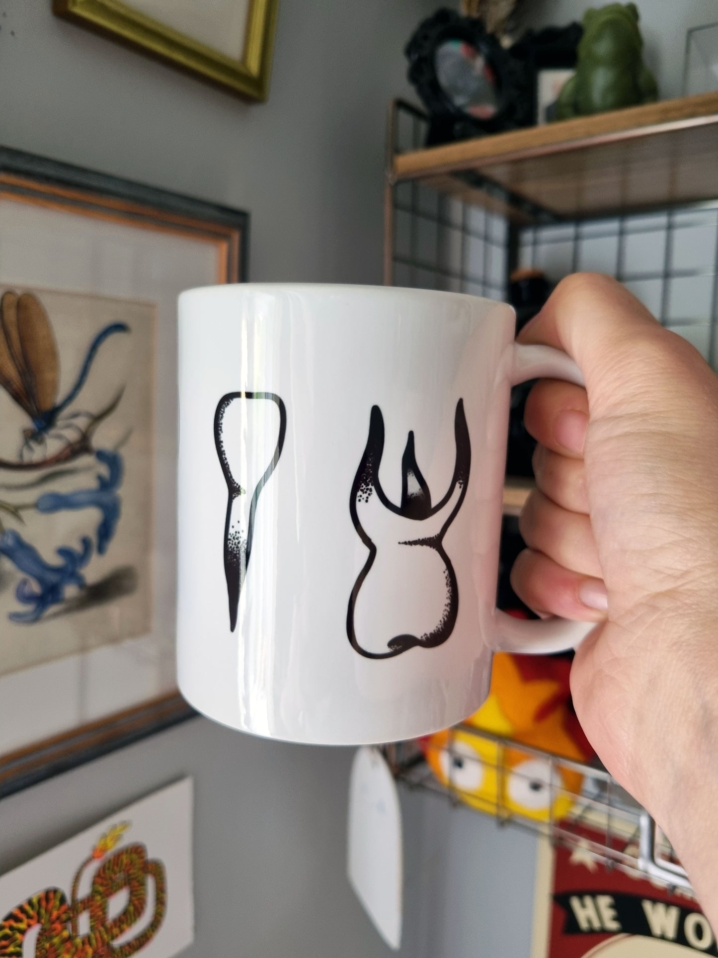 Teeth Teeth Teeth 11oz Mug - EmilsDoodles
A hand holds a mug that has a teeth design wrapping around the mug. The teeth have dot shading. One of the teeth is a molar and central tooth.