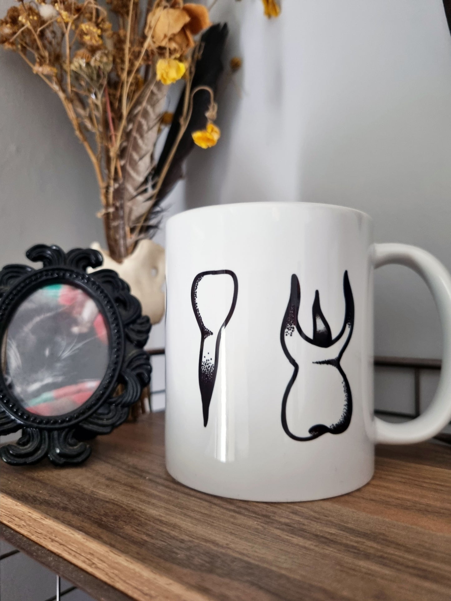 Teeth Teeth Teeth 11oz Mug - EmilsDoodles
A photo of the mug on a shelf.