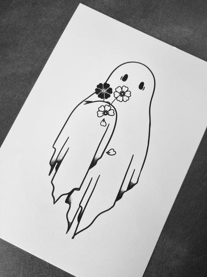 A picture of an art print. The art print features a ghost holding a small, wilting bouquet. The print is on a black background. 