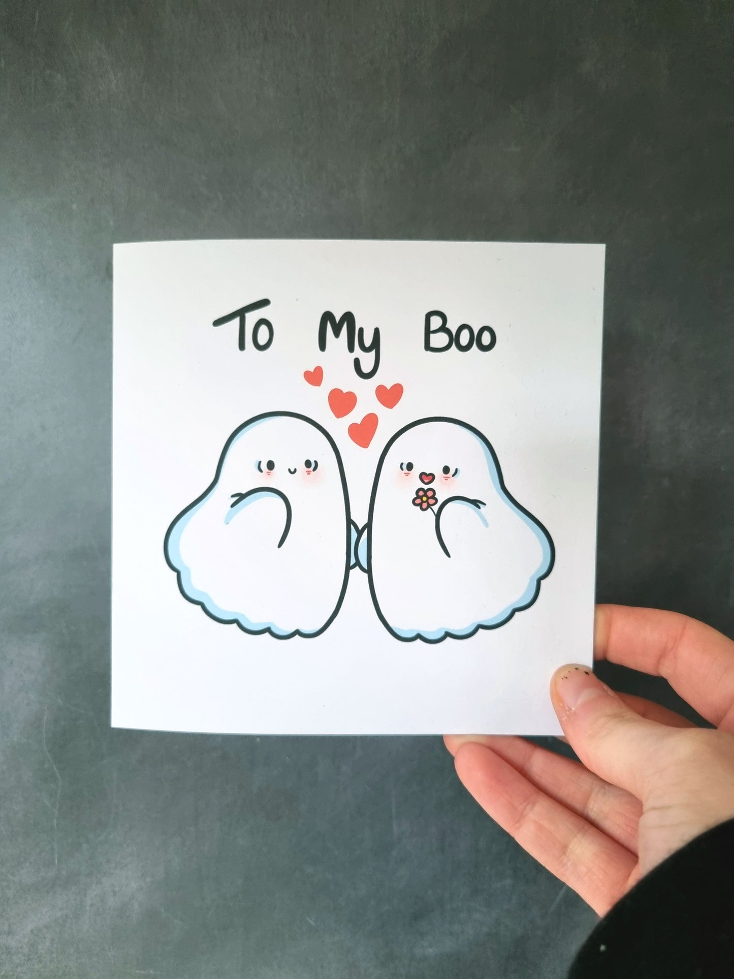 The same greeting card being held without the envelope. 